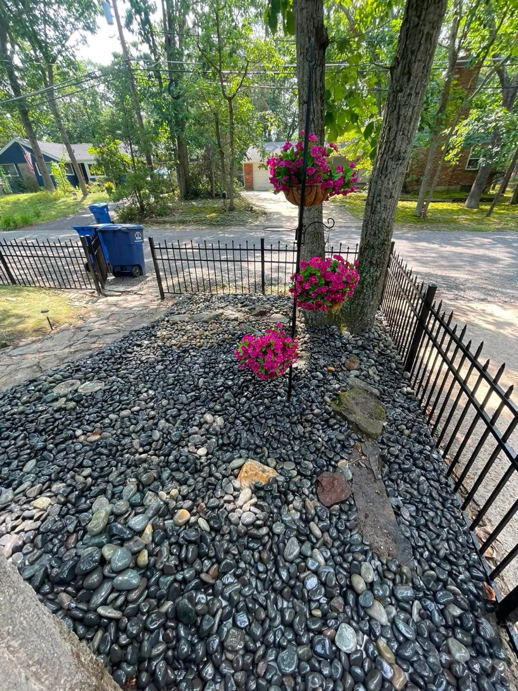Mexican Beach Pebble bed around a tree, with flowers
