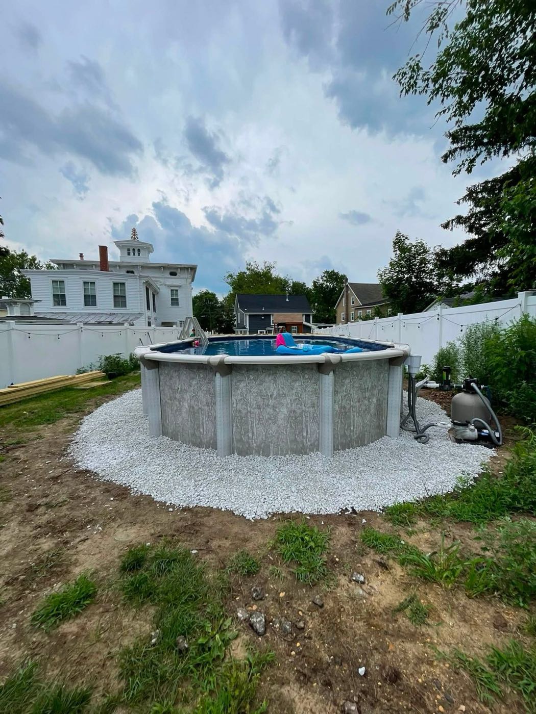 White marble chips around an above-ground pool