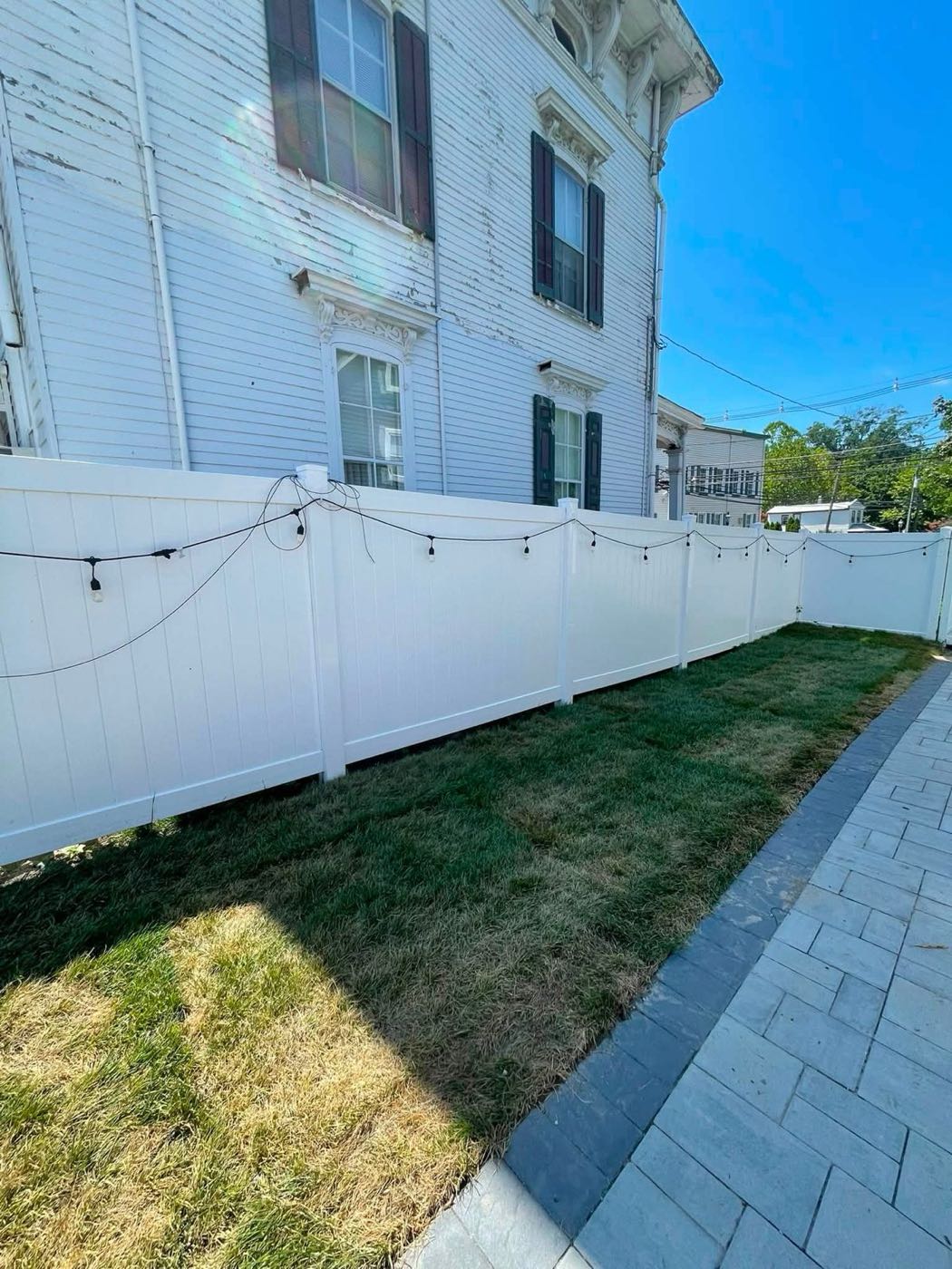 New sod beside a gray paver walkway