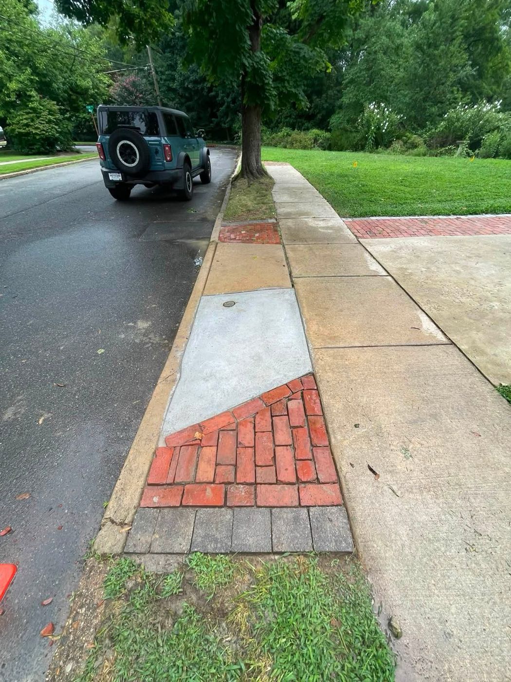 Replaced sidewalk section with reset brickwork