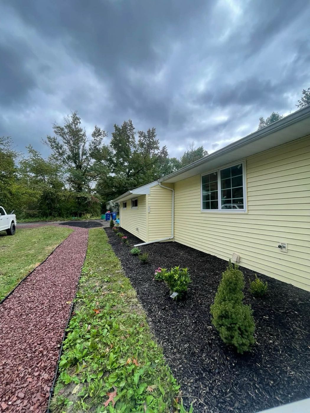 New crushed stone walkway beside fresh black mulch and plantings