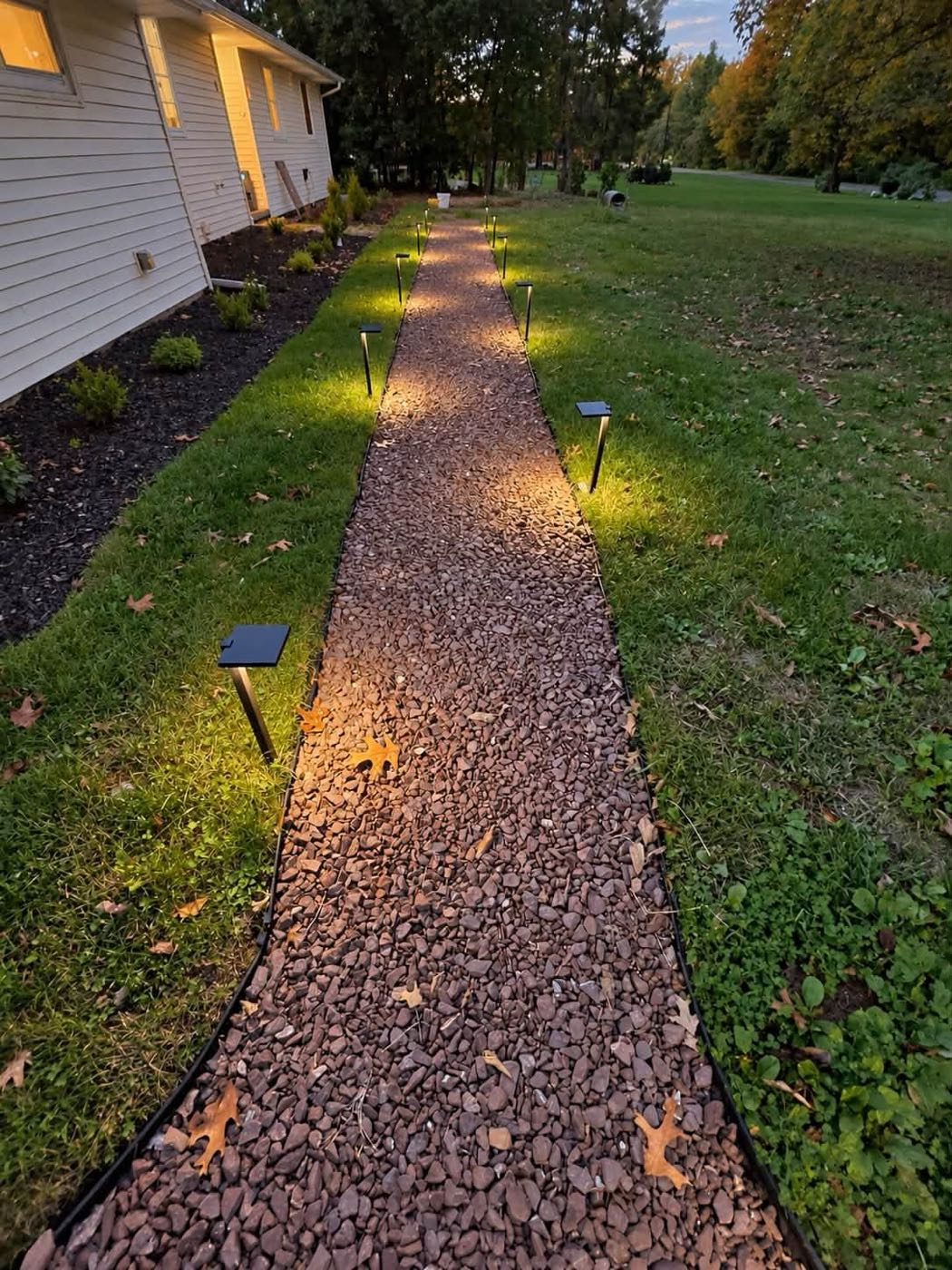 Crushed stone walkway lined with path lights